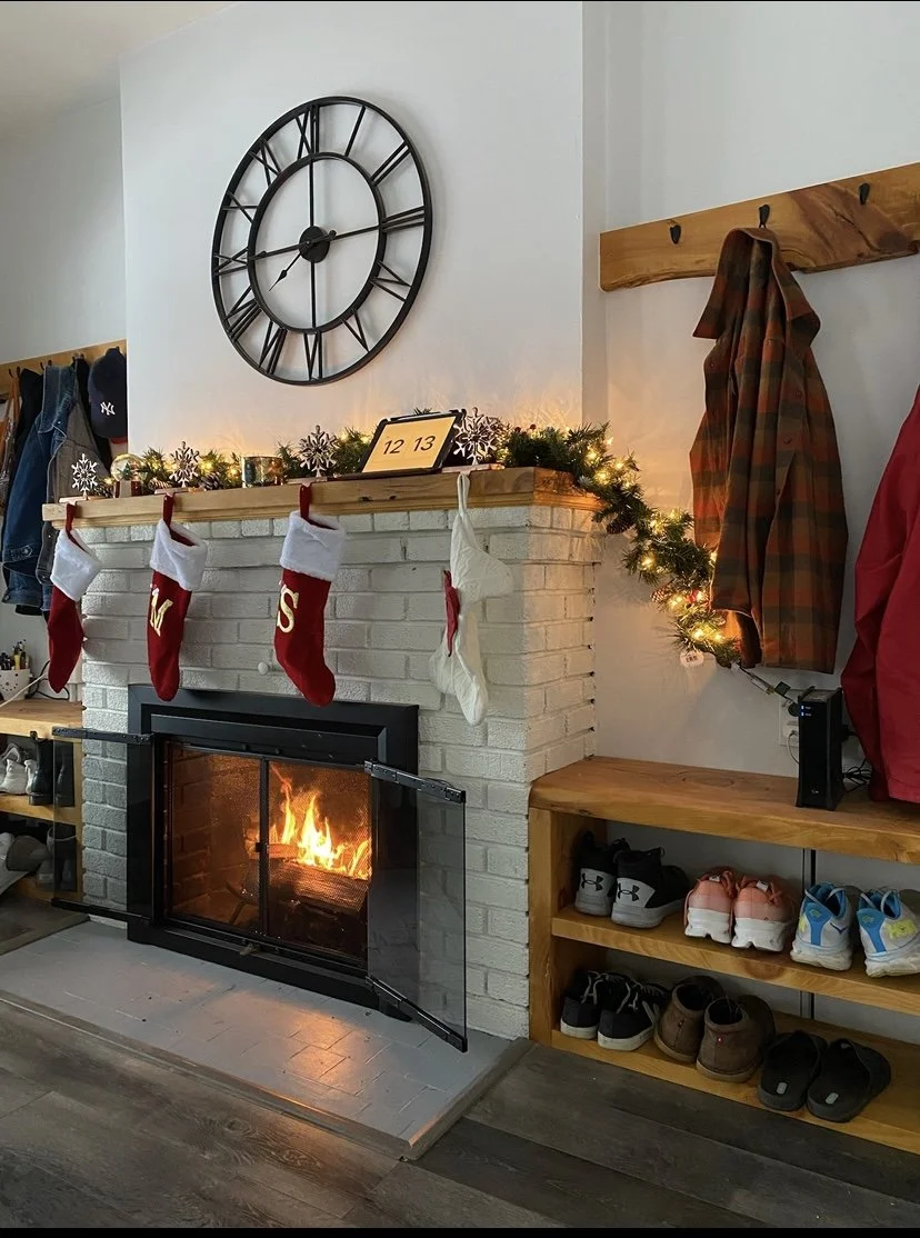 A custom built-in fireplace from Beverwyck Designs displaying white brick and oak wood.