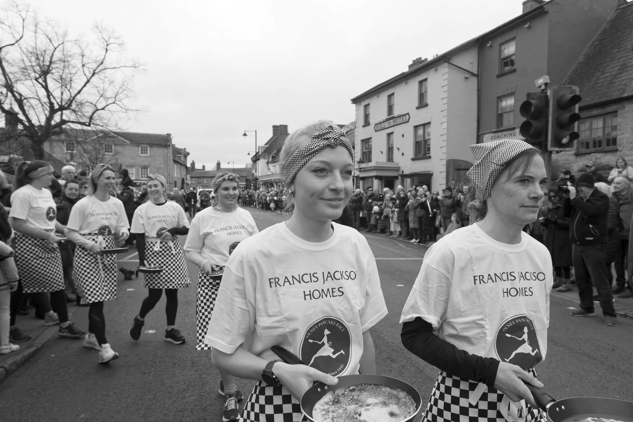 Women of Olney, Bucks approach the Pancake Day race starting line.