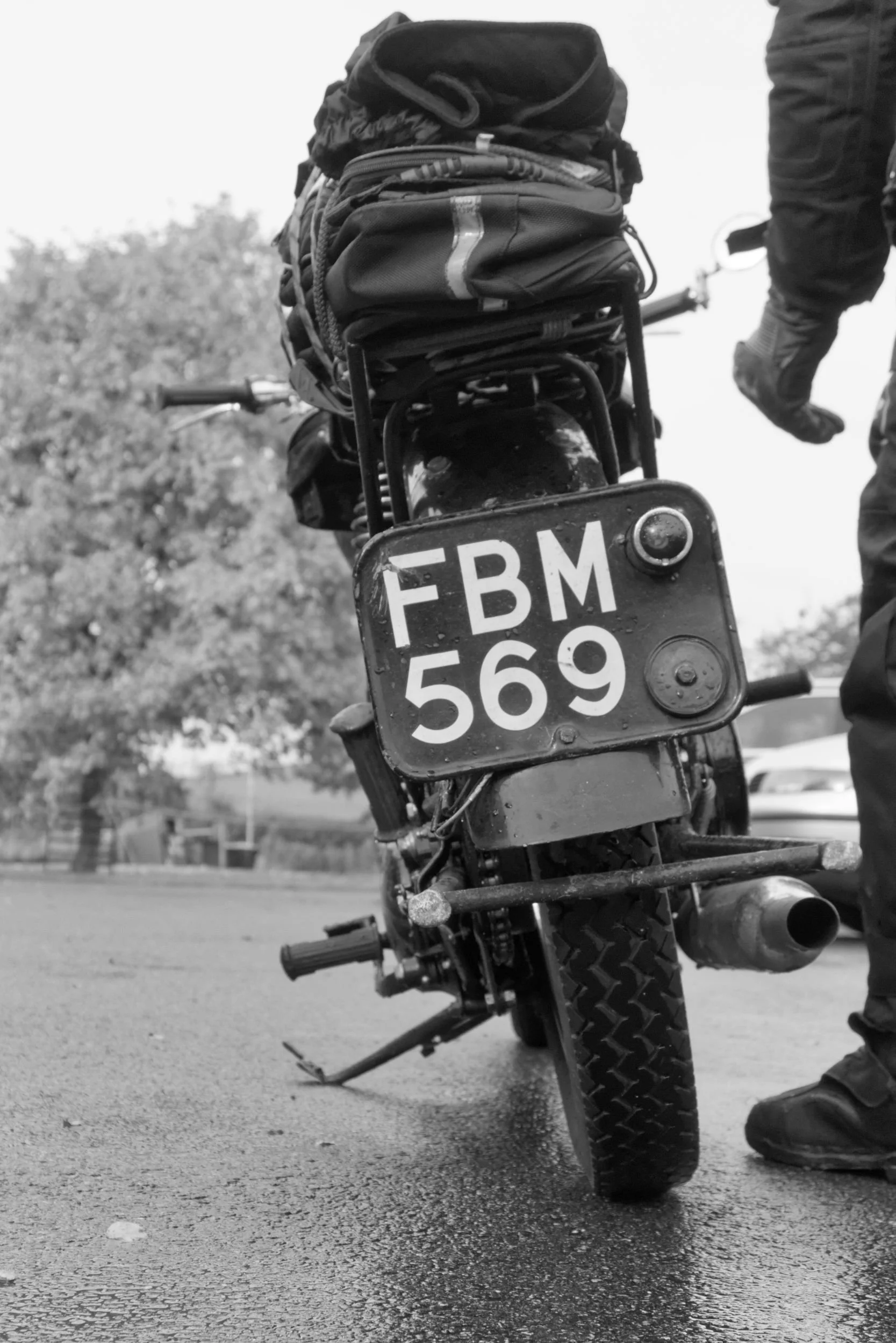 Rider of BSA M20 motorcycle prepares to set off in the rain.