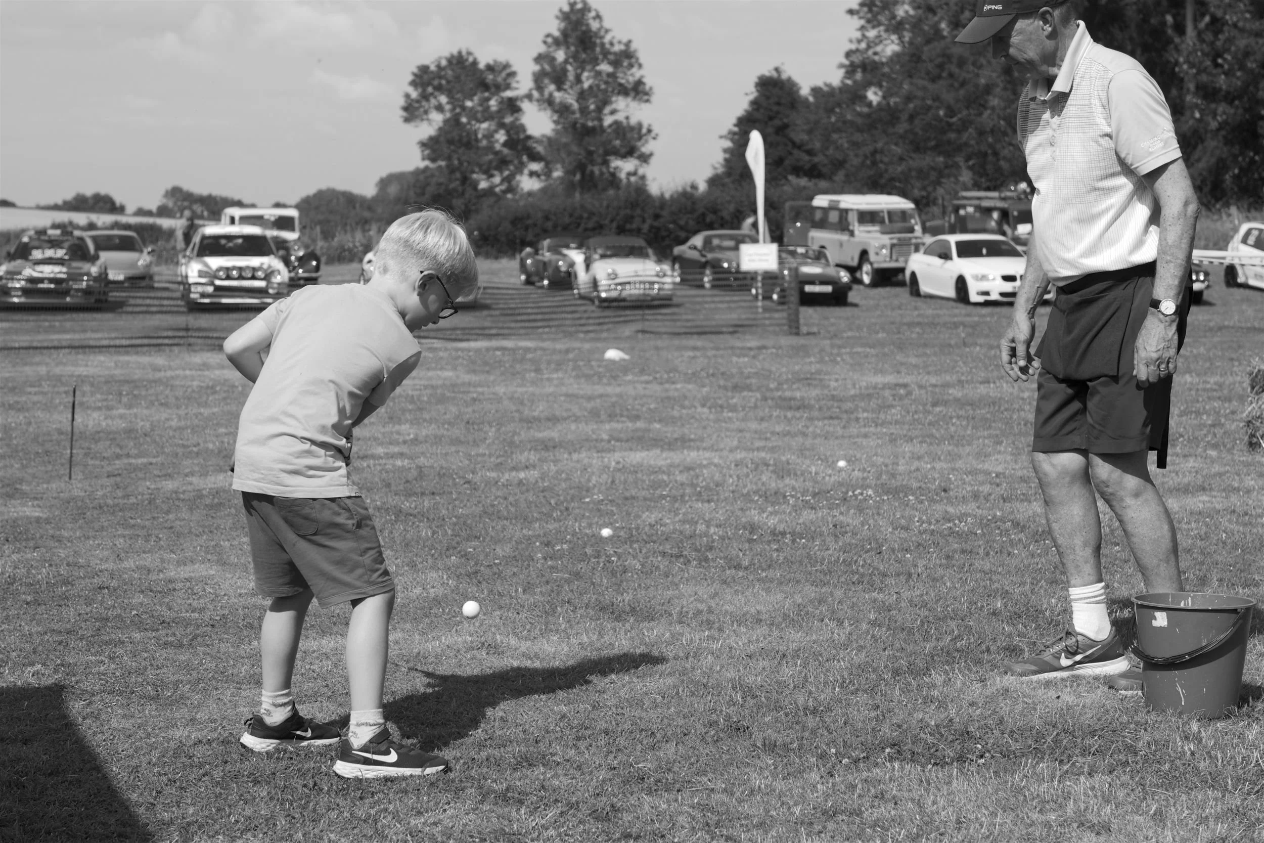 Young boy playing the golf game at the Little Horwood village fete.