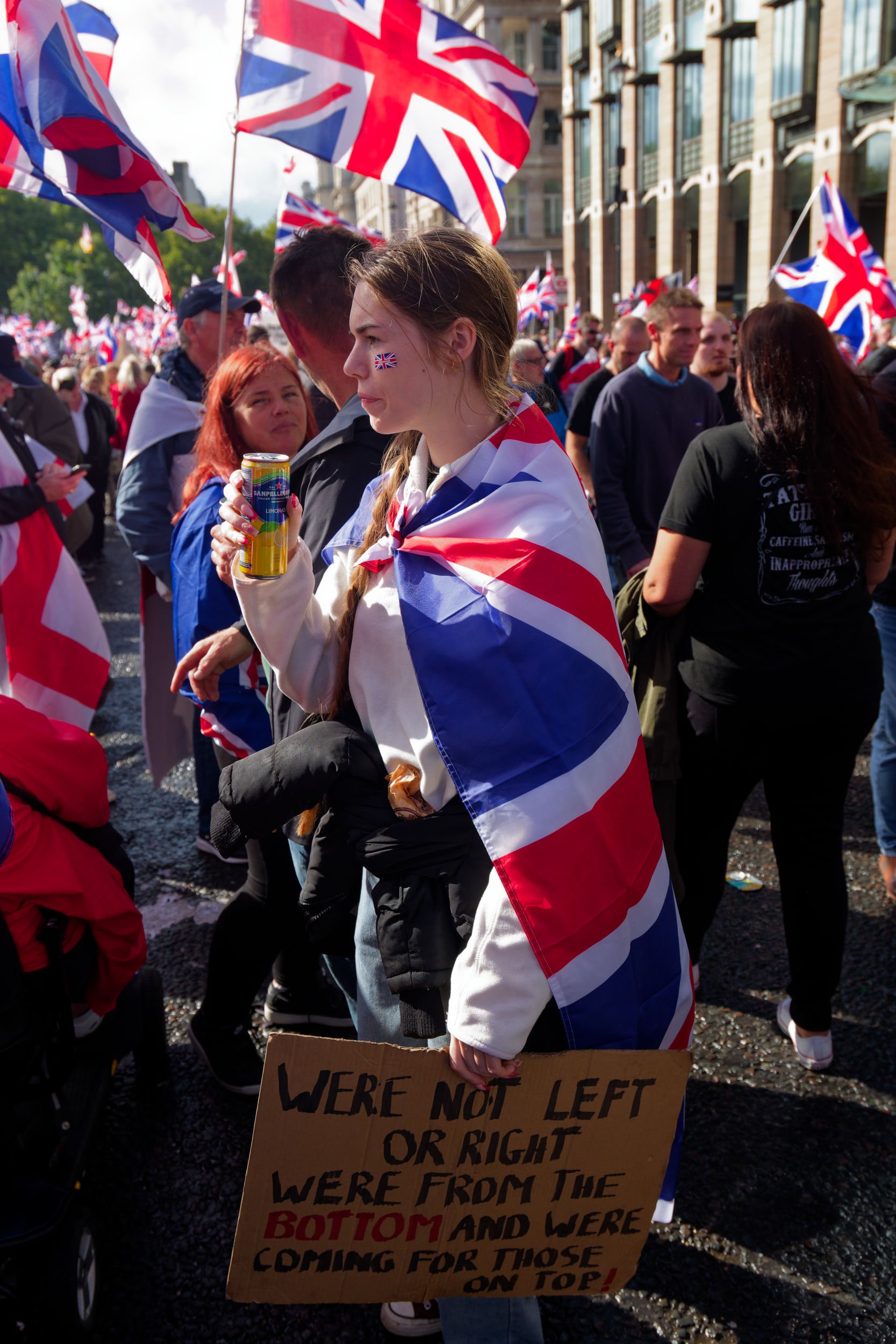 Woman with protest sign at Tommy Robinson's Unite the Kingdom march.