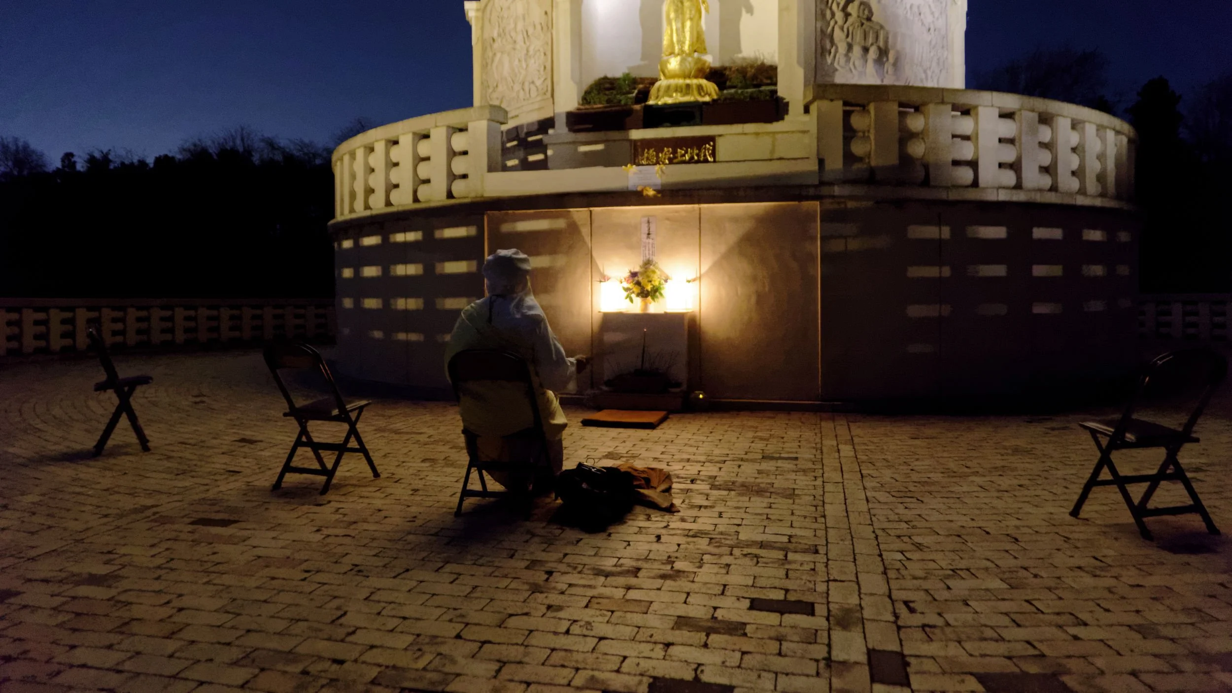 Buddhist nun chants at socially distanced ceremony, on Milton Keynes Peace Pagoda.