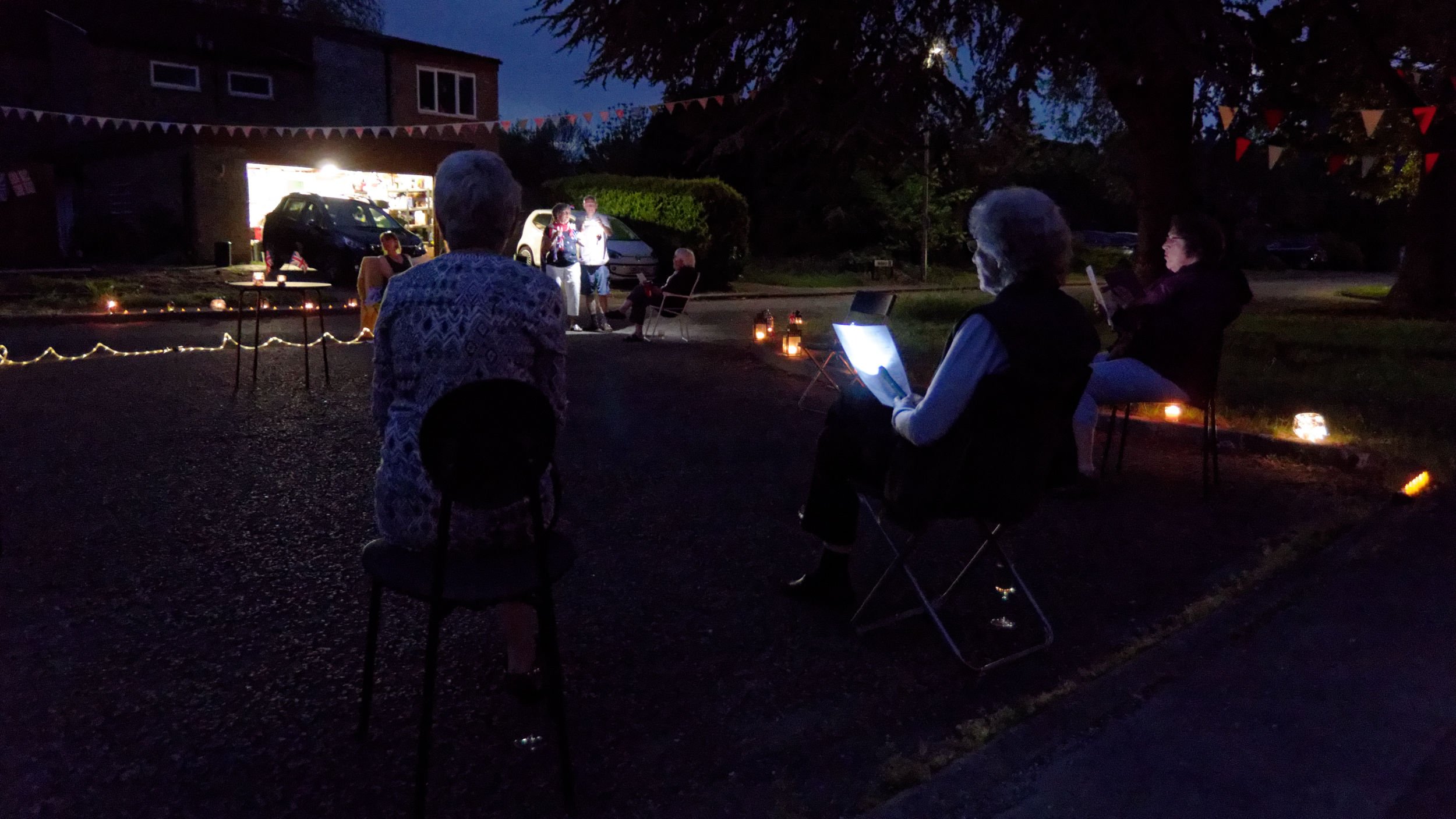 Neighbours gather in their car park for socially distanced VE Day party