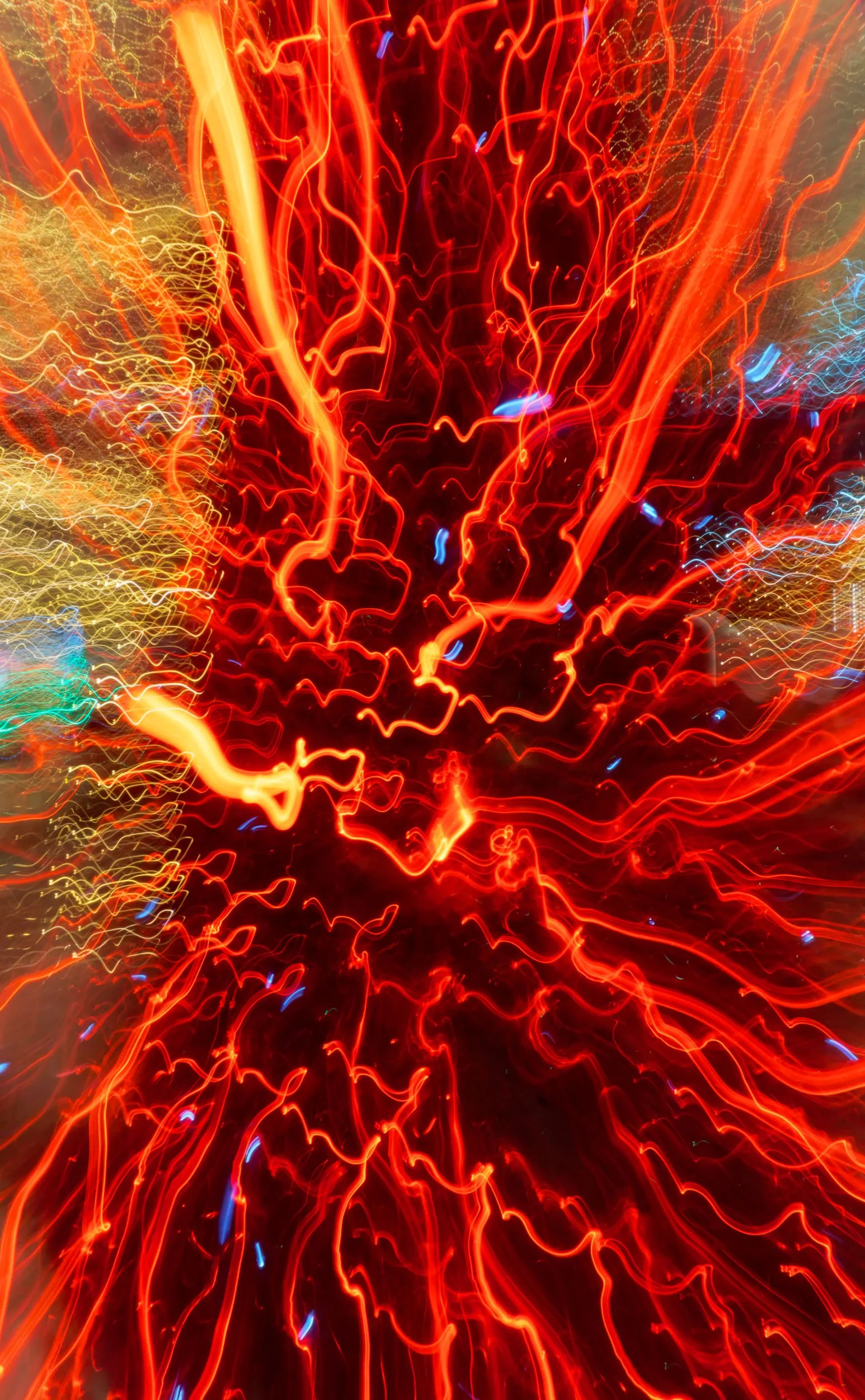 An abstract photo of red lights made by intentional camera movement.