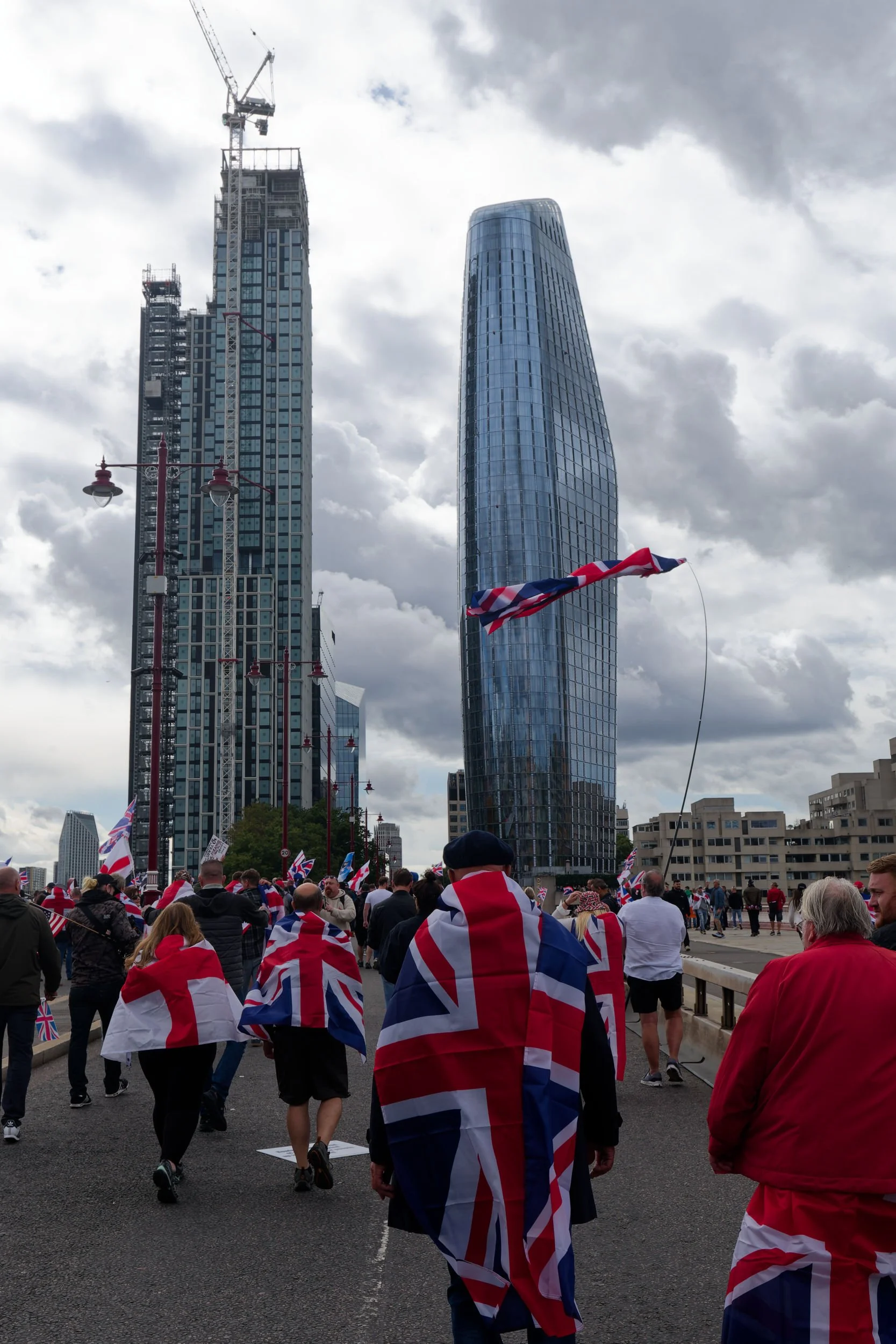 Unite the Kingdom march crosses Blackfriars bridge, many Union Jacks visible.