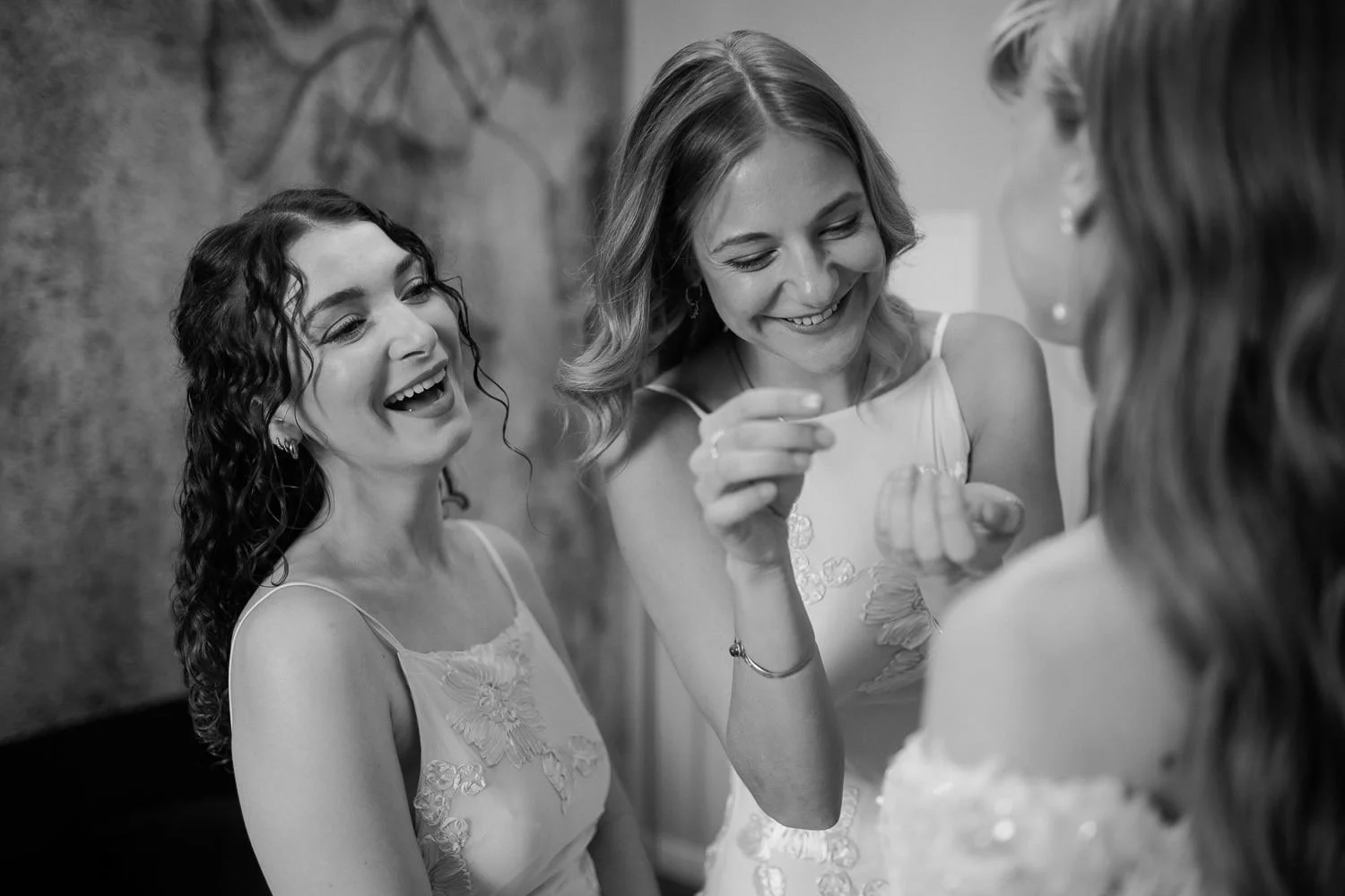 Braut mit Trauzeuginnen beim Getting Ready in Villa Bleichröder Usedom, Gemeinsames Lachen, Schwarz-weiß Foto