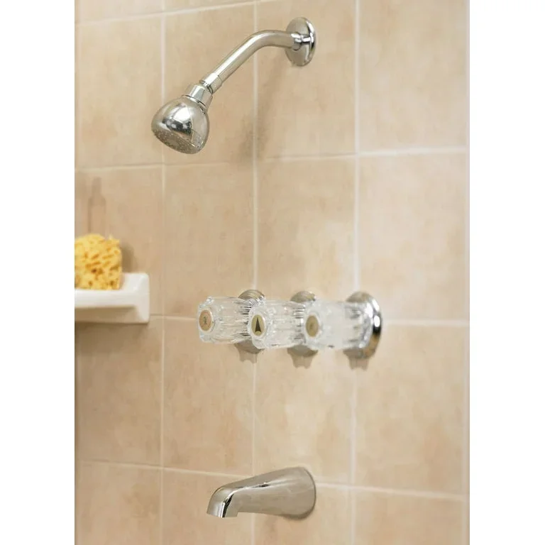 Bathroom shower with a chrome showerhead, a soap holder, and a faucet on beige tiled wall.