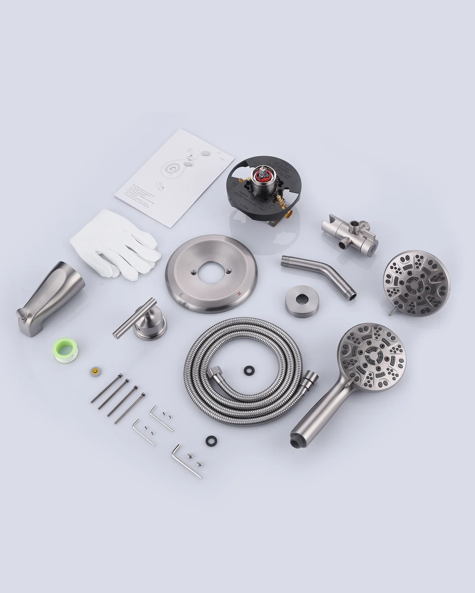 Disassembled bathroom shower faucet kit with various metal parts, hoses, and instructions laid out on a light background.