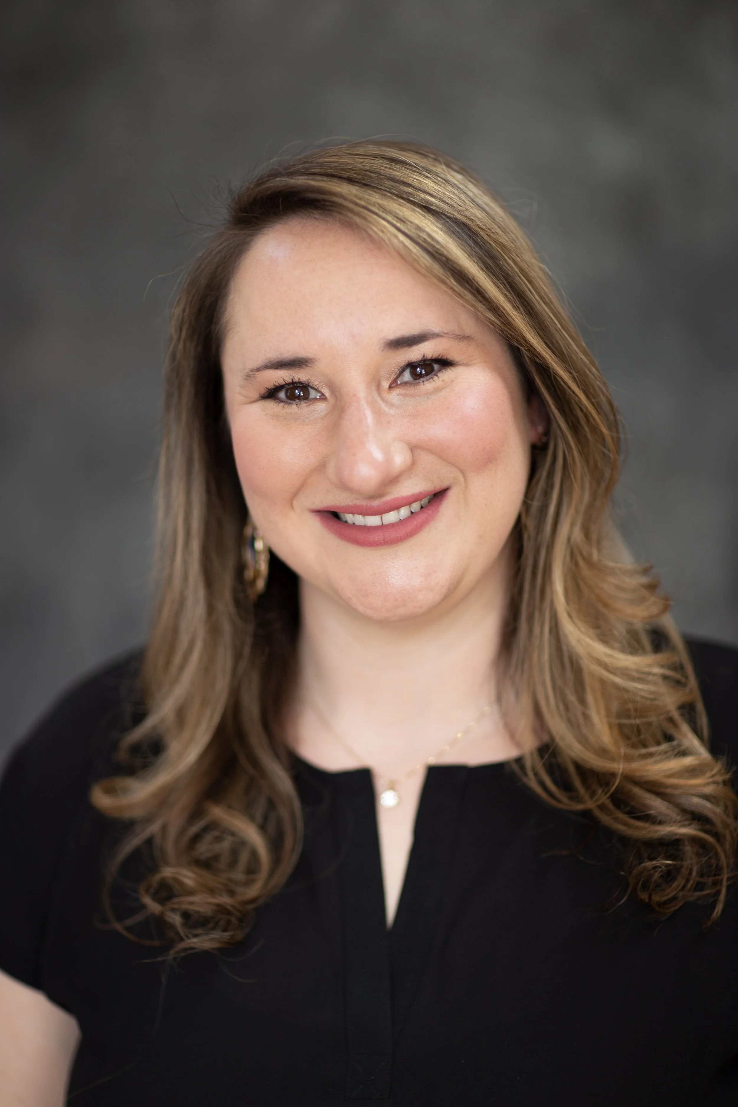 Danyel wearing a black tock and necklace