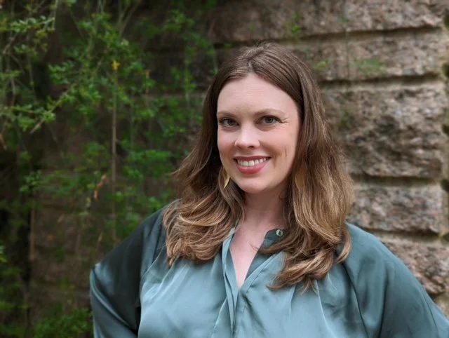 Jenna Sims wearing a blue blouse