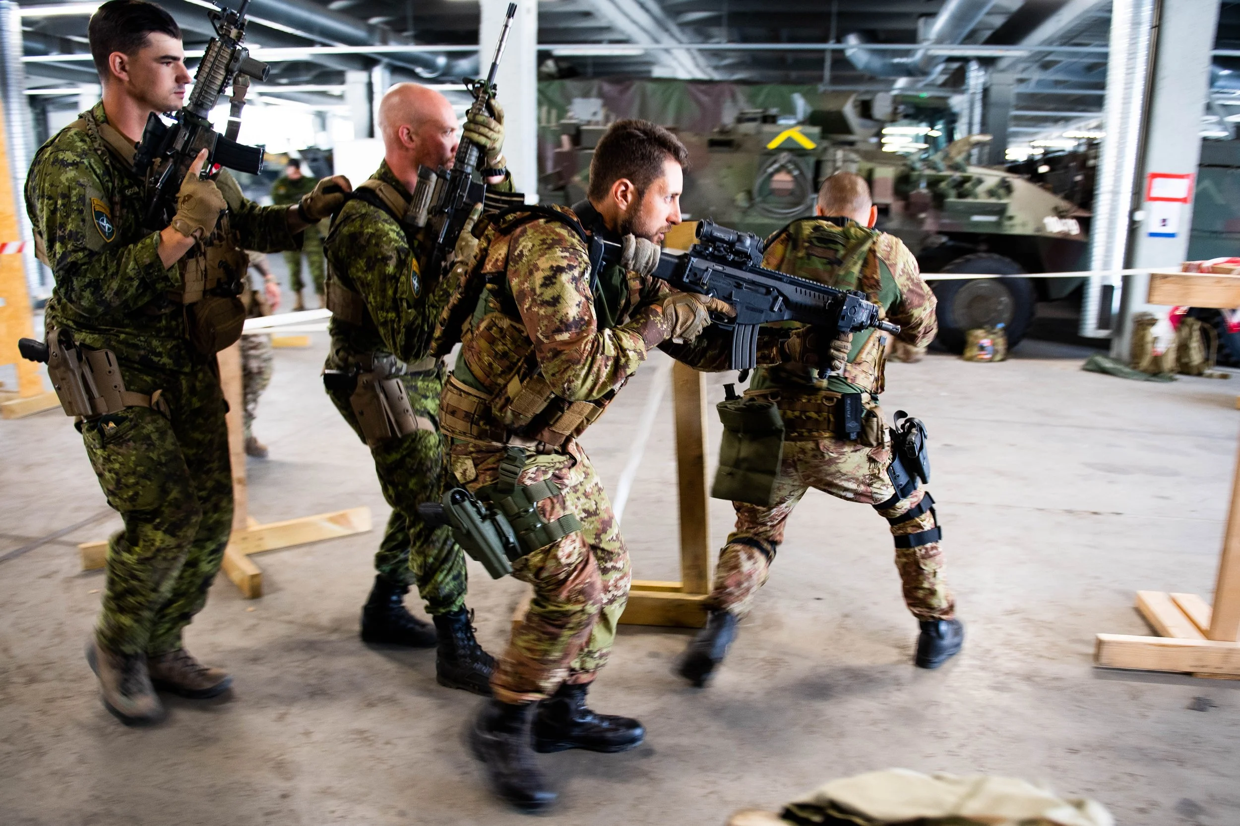 Canadian and Italian service members practice drills for close-quarters battle (CQB) in Adazi, Latvia.