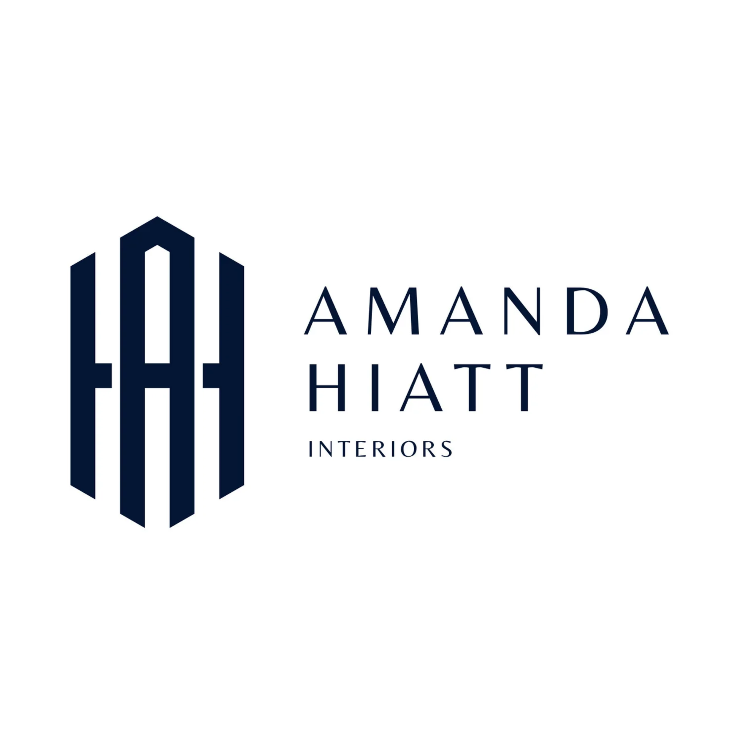 Logo for Amanda Hiatt Interiors, featuring a stylized navy blue geometric building design and the company name in navy blue text.
