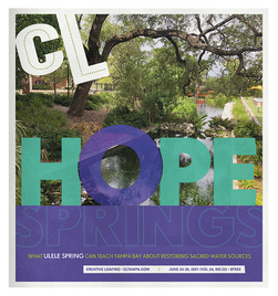 Close-up of large colorful letters spelling 'CLOVER HOPE SPRINGS' against a background of trees and greenery.