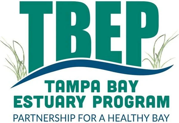 Logo for the Tampa Bay Estuary Program, featuring large green letters 'TBE' with grass illustrations on both sides and the text 'Tampa Bay Estuary Program' and 'Partnership for a Healthy Bay'.