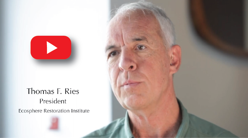 Picture of a man with gray hair and a serious expression, standing in front of a presentation slide with his name and title, and a YouTube logo in the top left corner.