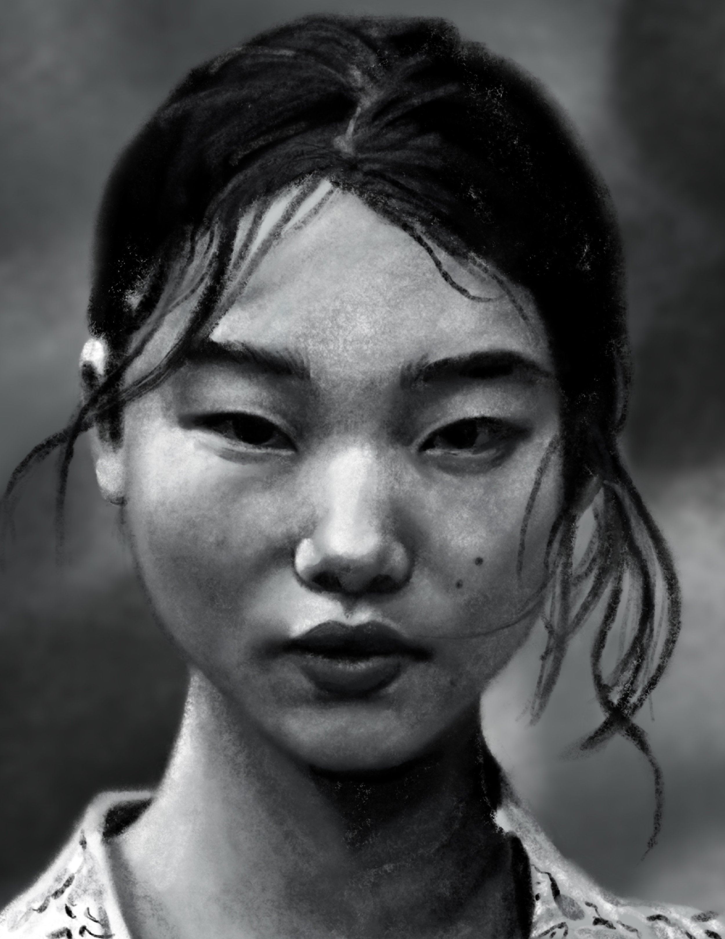 Black and white close-up of a person's face, focusing on the eyes, nose, and lips. The person has dark hair flowing around their face.