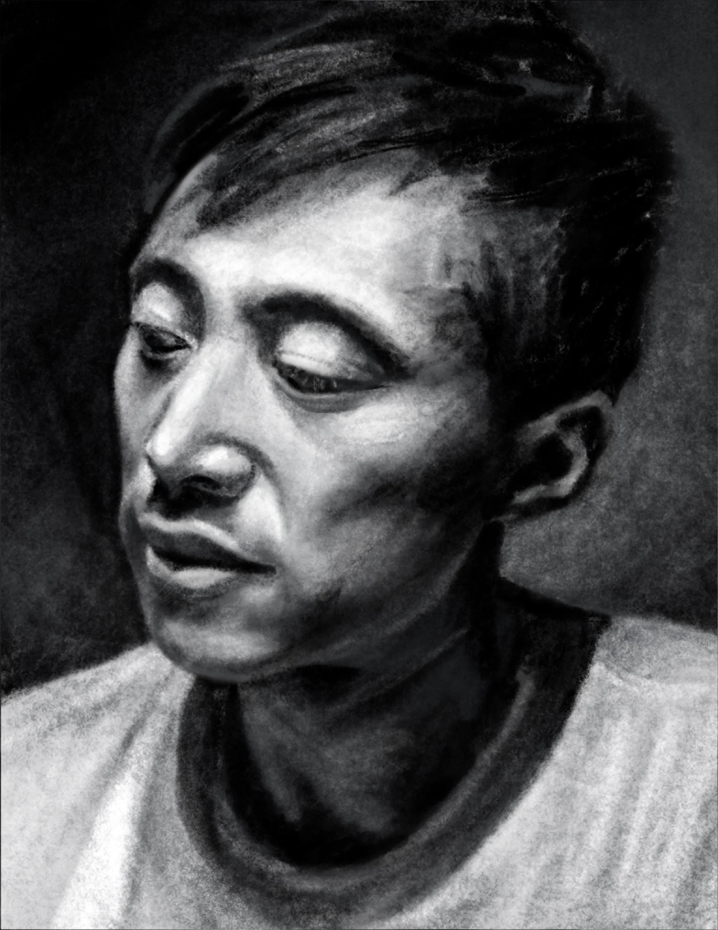 A black and white portrait of a person with short dark hair, looking downward with a reflective expression.