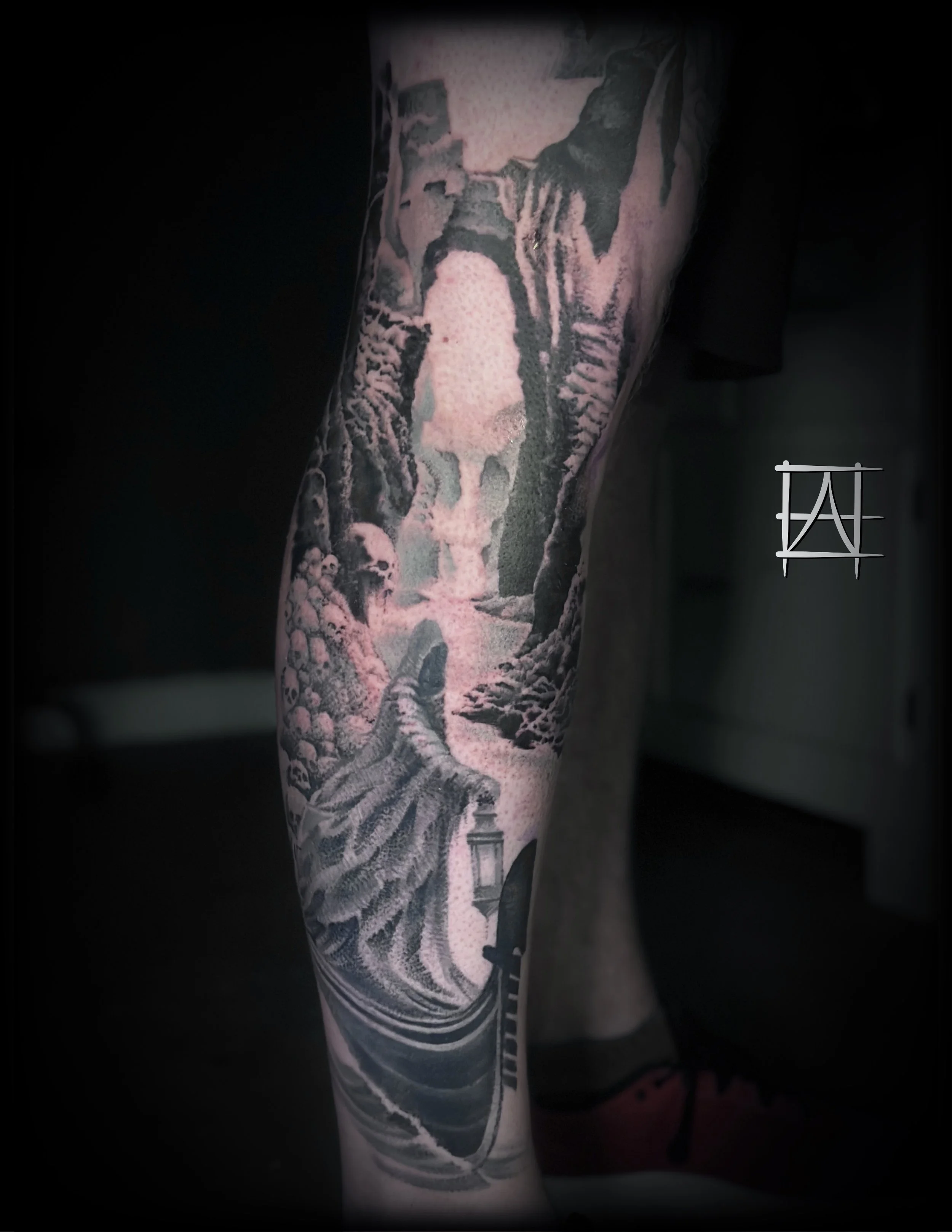 Tattoo of a detailed landscape scene with river Styx and Charon on a person's arm.