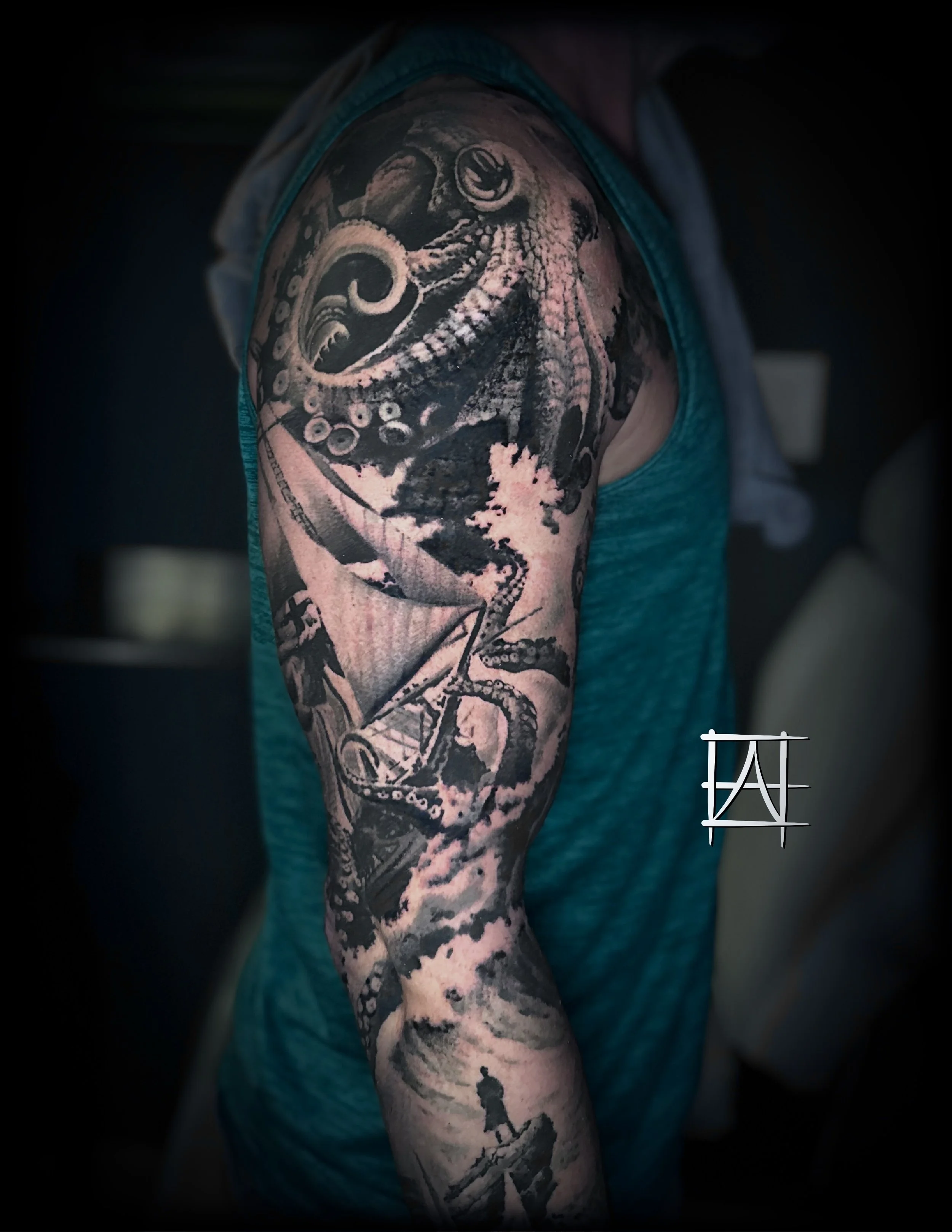 Tattoo of an octopus on a person's upper arm, with detailed shading and intricate design.