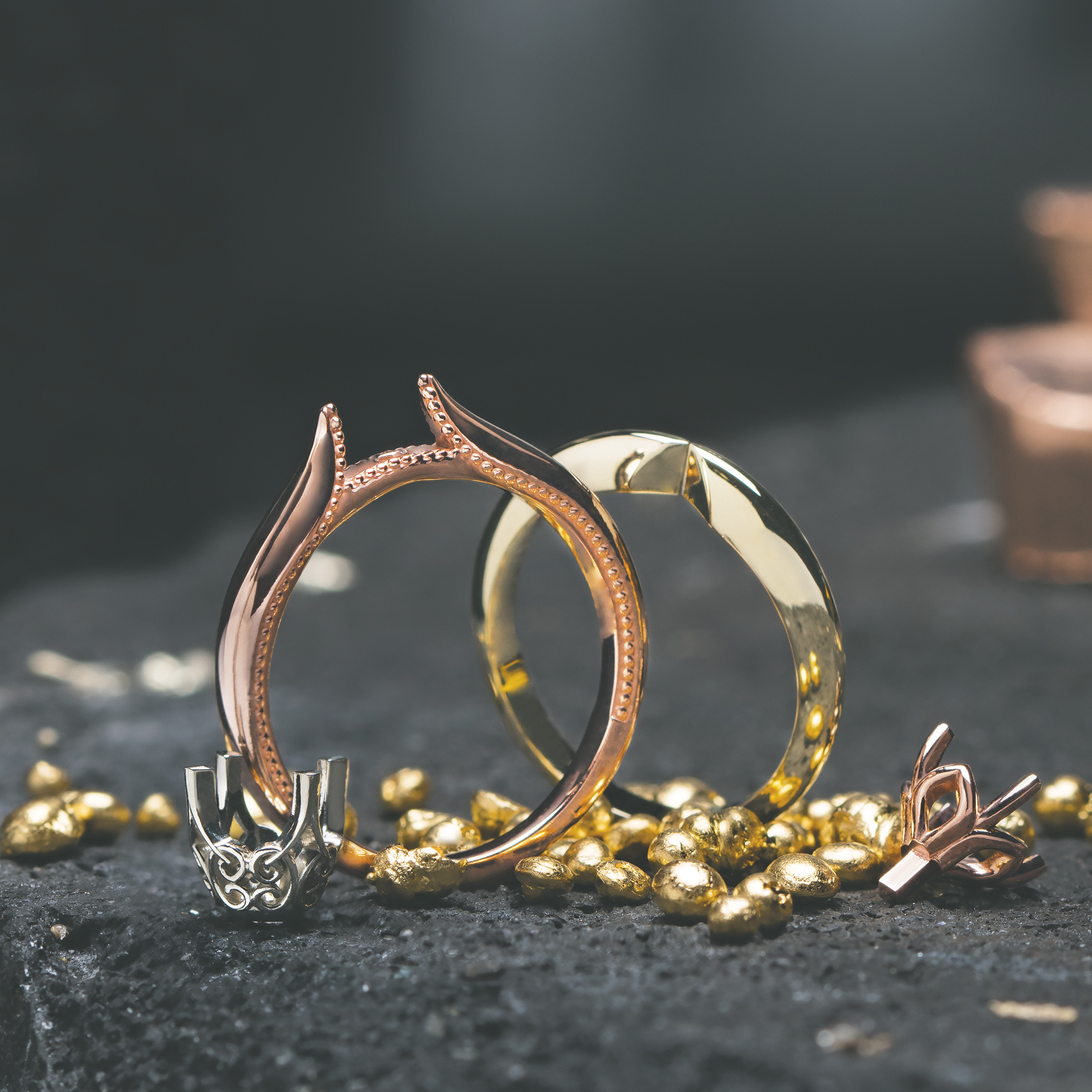 Rose and yellow gold ring shown as incomplete during the casting process.