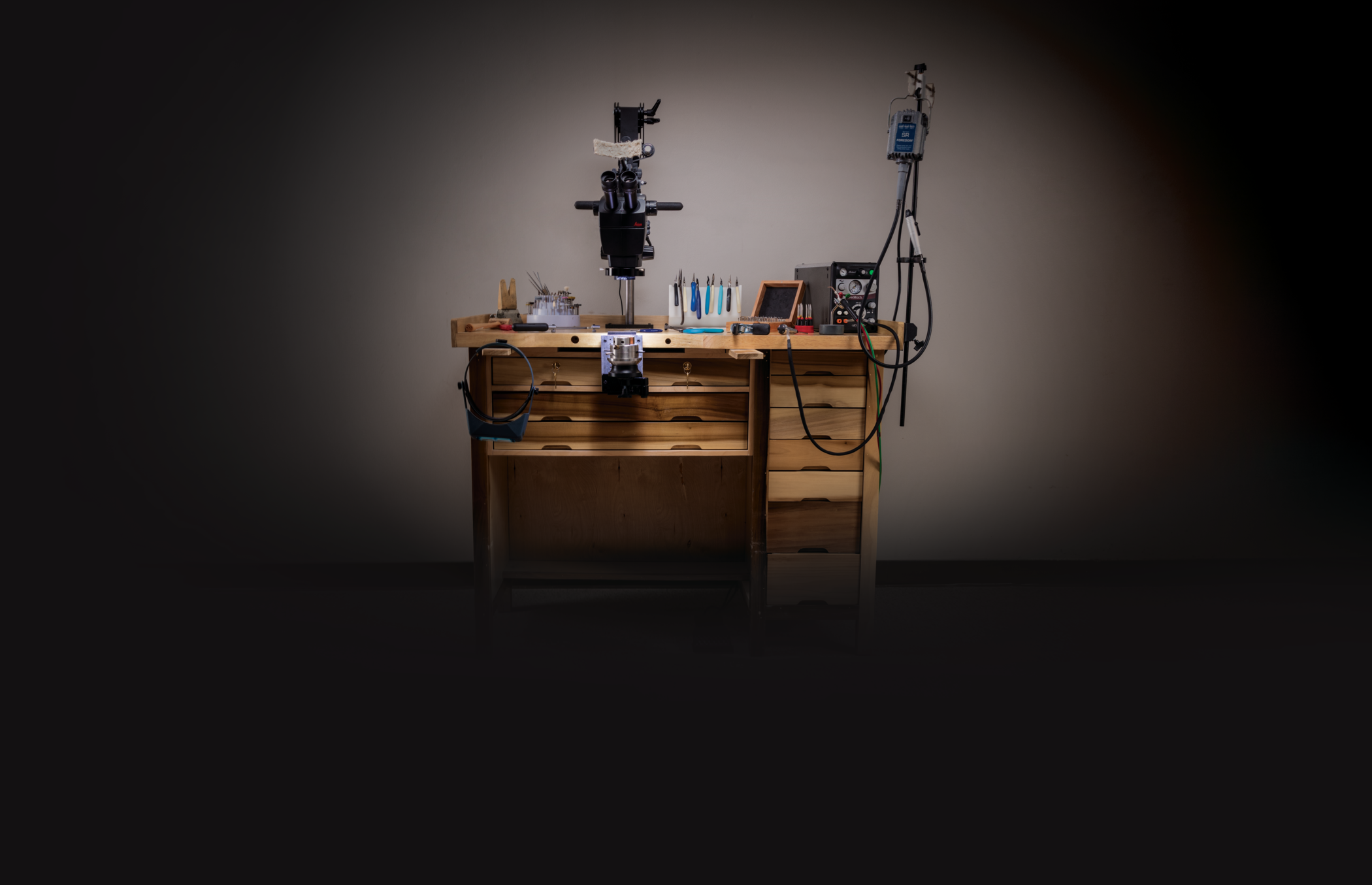 Jeweler's workbench with assorted tools on it.