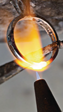 Torch flame against a gold ring that is being professionally resized.