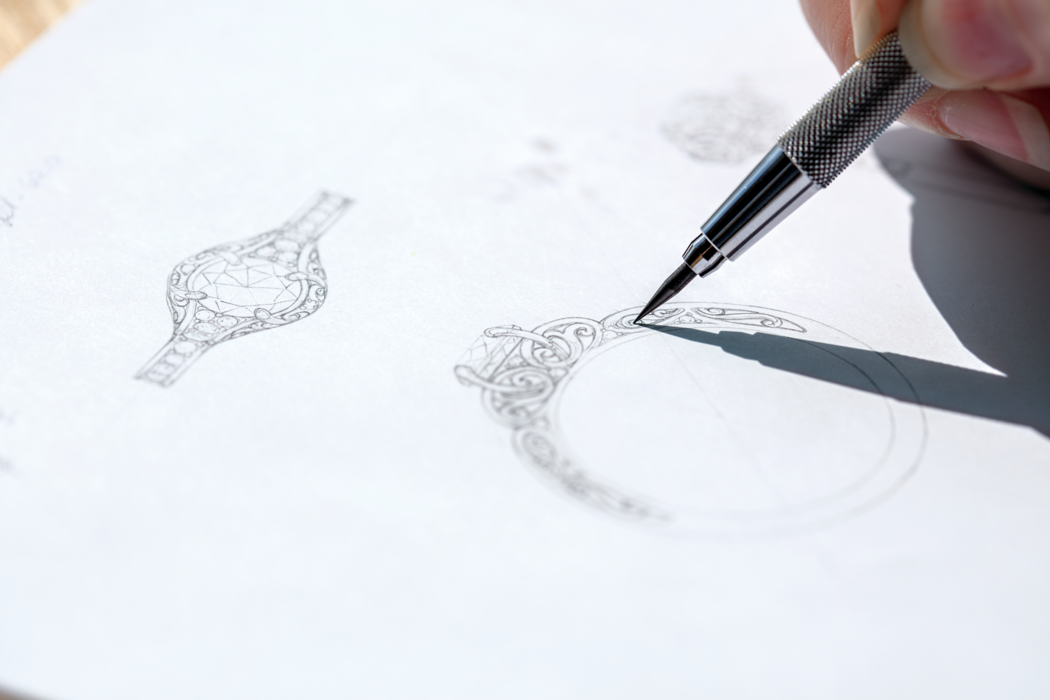 Drawing of a custom engagement ring design on white paper.