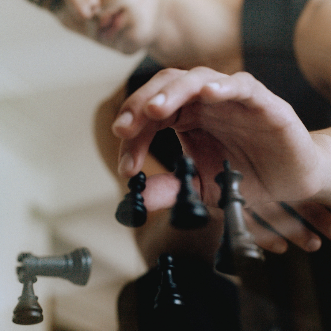 Hand moving a chess piece, symbolizing strategic decision-making and long-term content planning