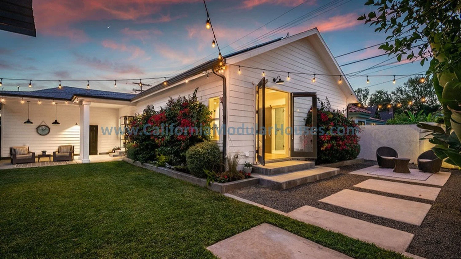 This shows the rear of the modular home with a rear view of the site built garage, just as we designed it for our client's exacting needs and to maximize the property to its full potential.  