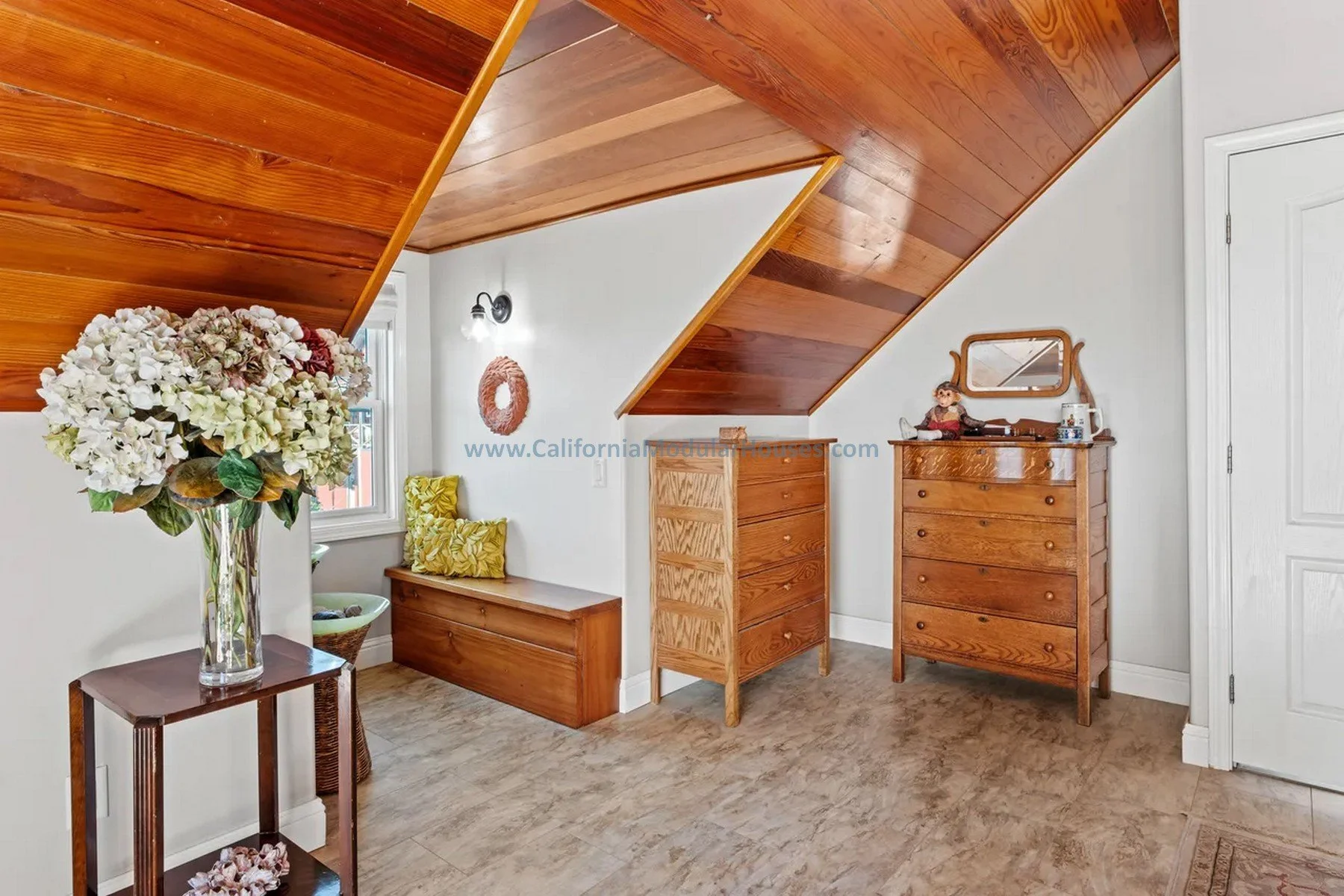 Corner of a room with wooden ceiling and white wall.  Prefab Modular Single Family Residence. California. Cape Cod home with attic finished on-site.