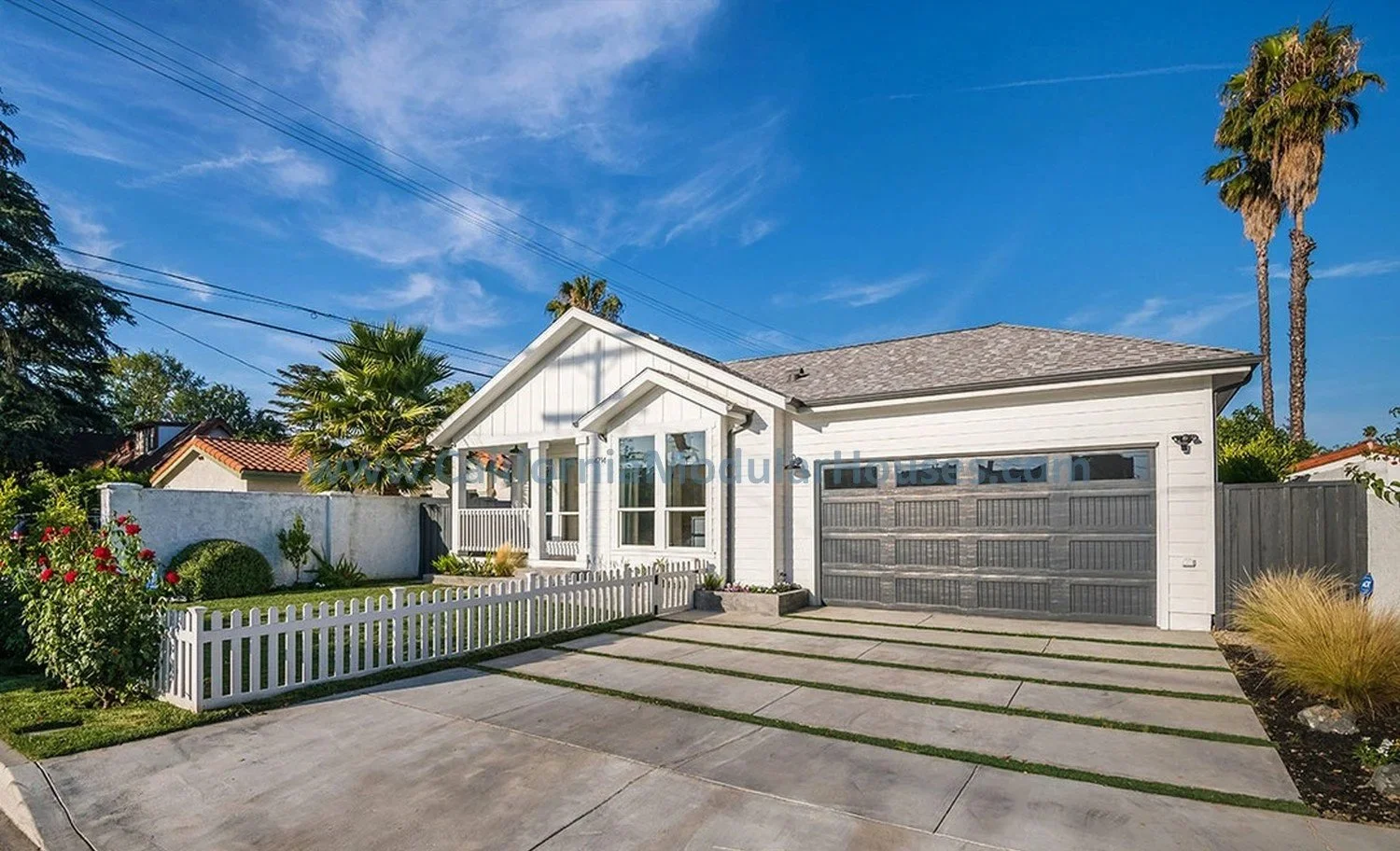 This is a Modern white modular house with a gray garage door.  This home shows what we can design and built to meet our clients needs.  This is in Toluca Lake, Los Angeles County, California.  