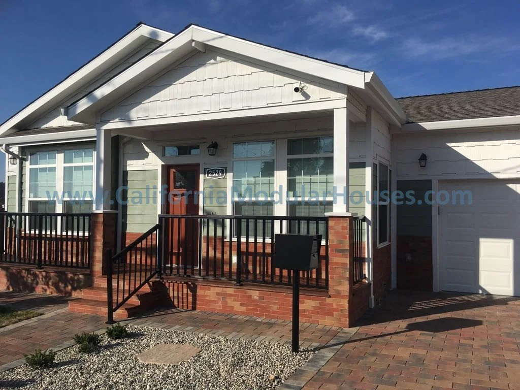 Sage green home with white trim, cherry red door built in Pinole, Contra Costa County, CA designed by California Modular Houses, Inc.