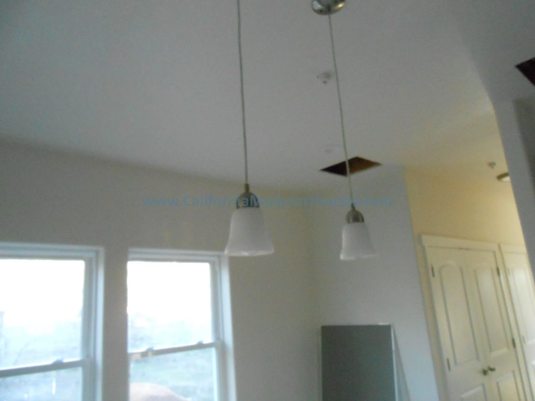 A kitchen ceiling with two pendant lights.  Cobb Mountain, Lake County, California.   Modular Homes Northern California, The San Ysidro Falls model by CaliforniaModularHouses.com. 