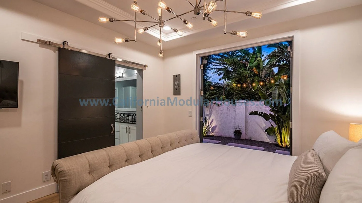 This room has beautiful French doors that open out and a barn door to the bathroom, large floor molding.  There is a coffered ceiling with moulding to make the ceiling even taller.  Factory Built Housing.  