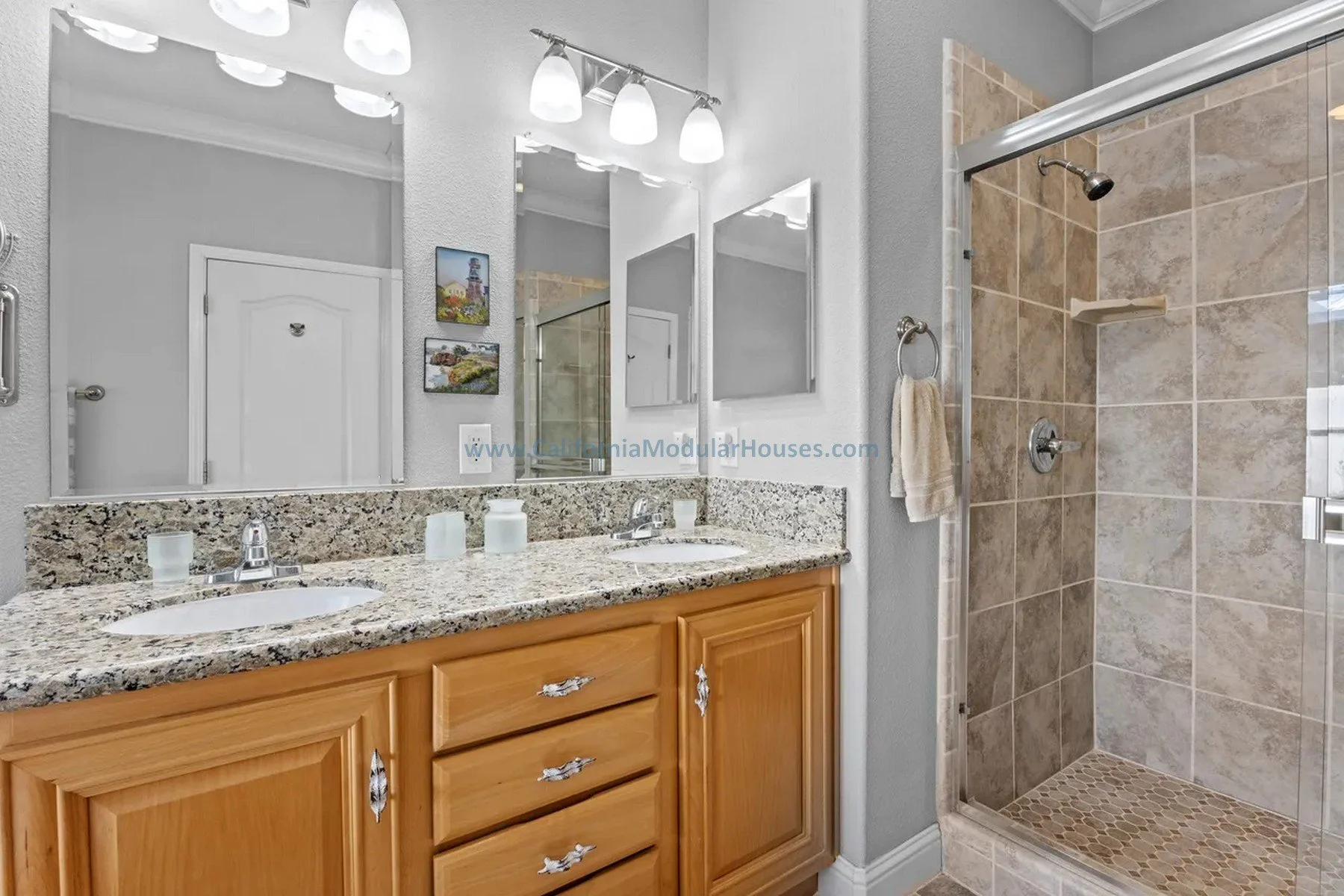 Historical design. Mendocino City, CA. Factory Built Home.  Mendocino County, California. Bathroom with granite countertop vanity and a walk-in tiled shower.
