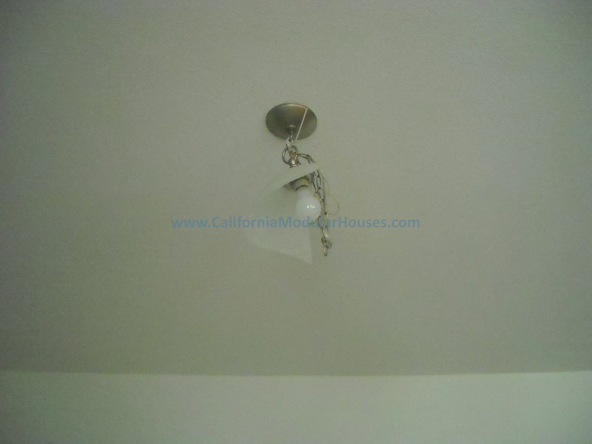 The chandelier was installed in the factory, just tied down to prevent damage to it and you can make it whatever length you want (if you want a dining room table underneath it or not).   Modular home.  