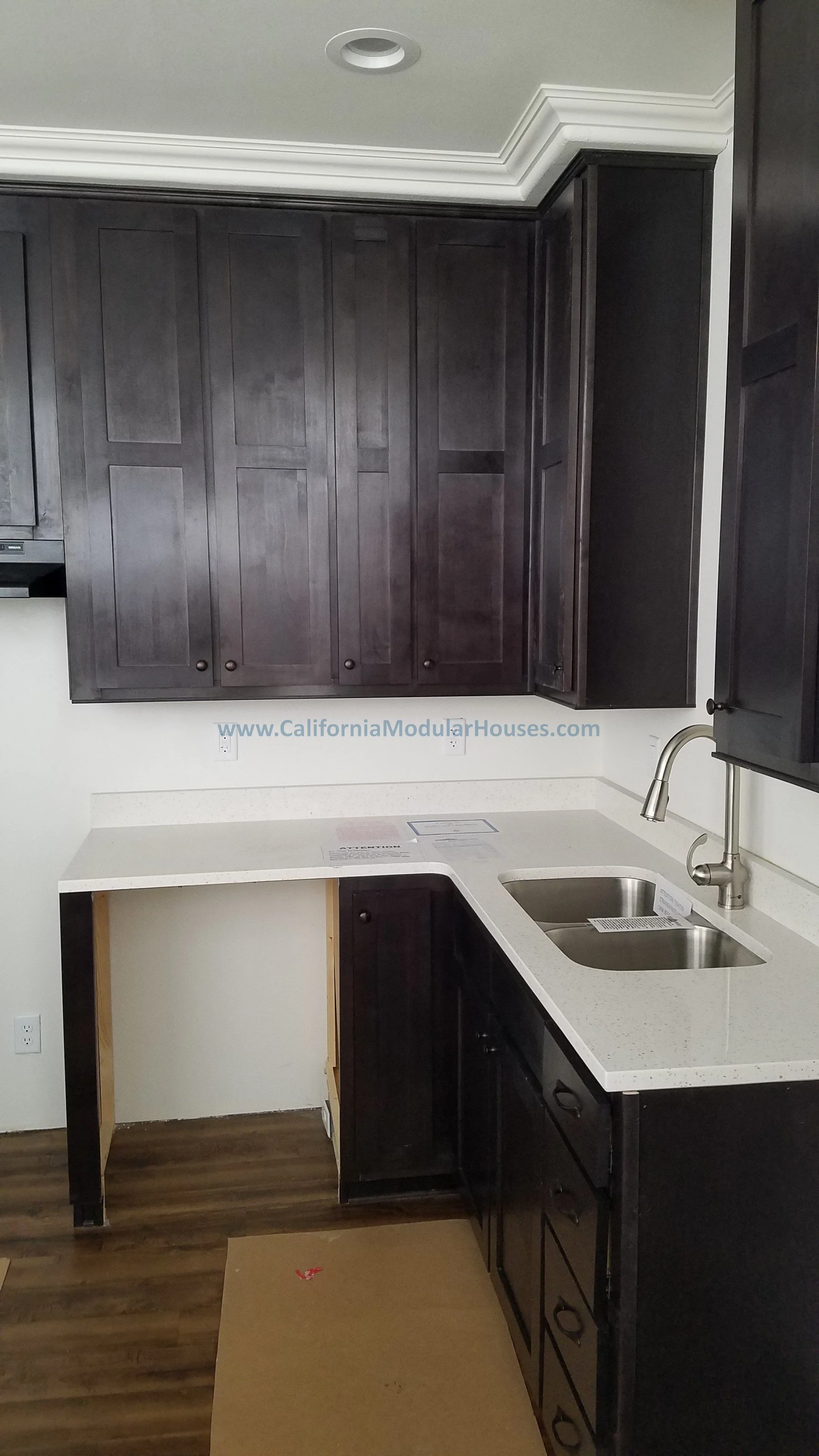 Kitchen with black cabinets, white countertop, and stainless steel sink.  California Modular Home,  Modular Homes, Modular Homes California, Modular Homes in California,