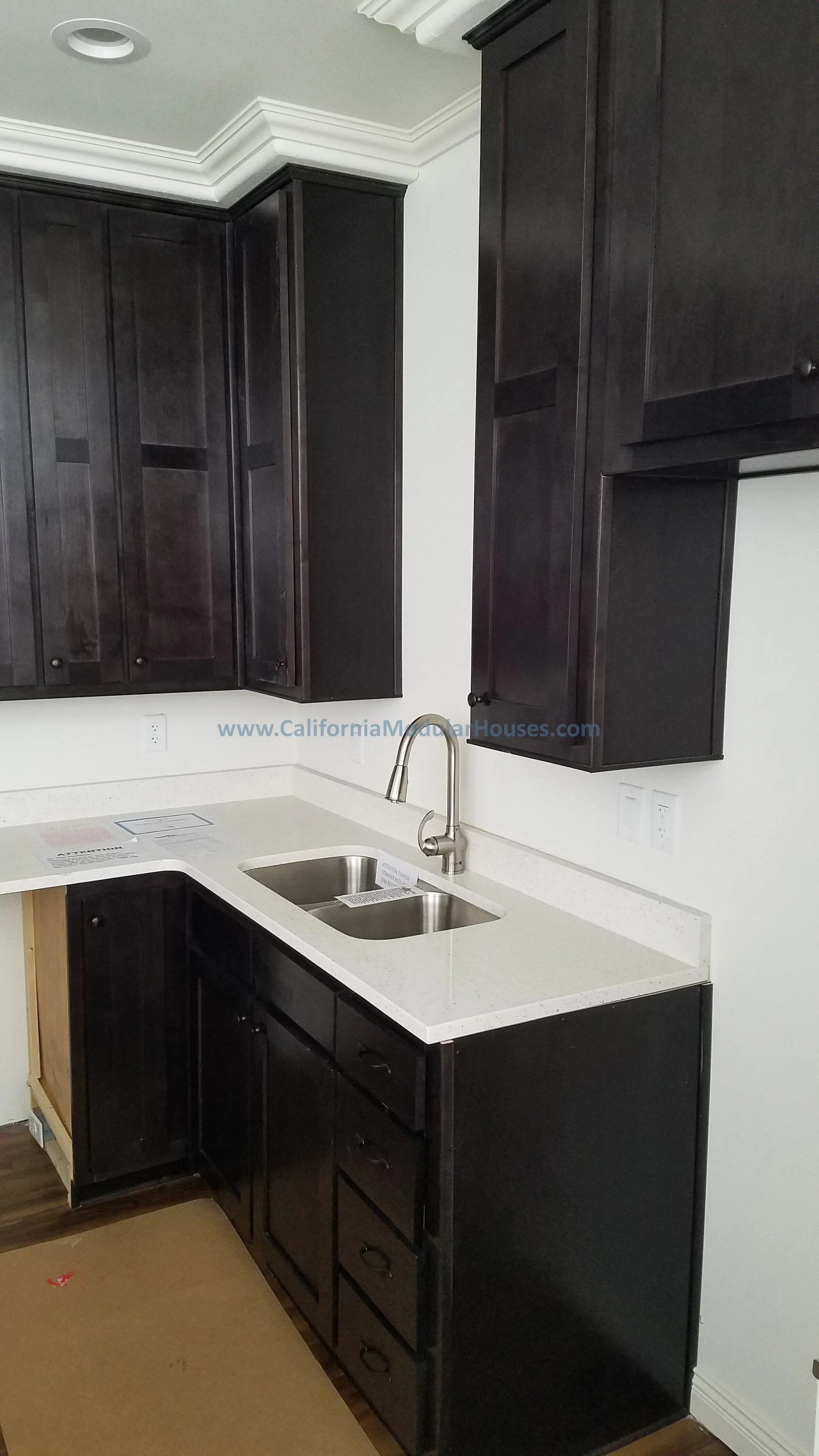 Kitchen sink with dark cabinets and a white countertop.  Modular Home CA, California Modular Homes, Prefab Modular Homes California, California Modular Home, 
