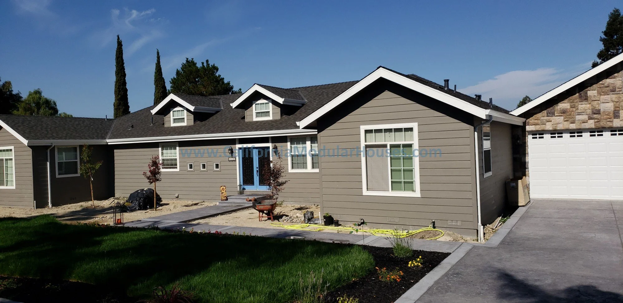This home shows how a modular home can look.  It can be finished however you want with siding, rockwork, dormers, accent paint colors, nice landscaping, and a large site built garage.  
