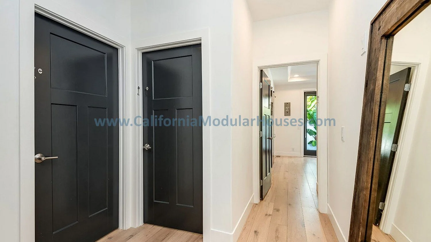 Here is the hallway of this modular home with beautiful wood doors and brushed satin fixtured were installed on-site in this home after the modular home was delivered to Los Angeles, California.  
