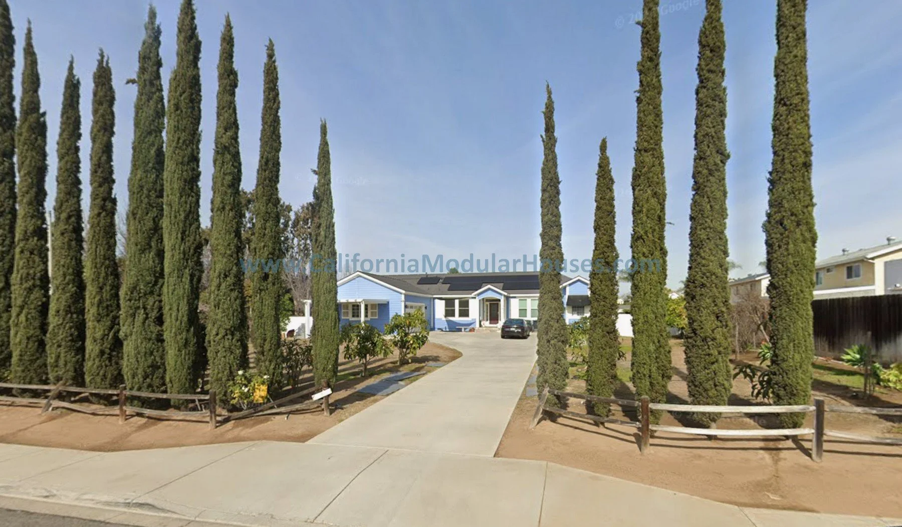 Prefab modular home, blue siding, white trim, gray roof built in Poway, San Diego County, CA.