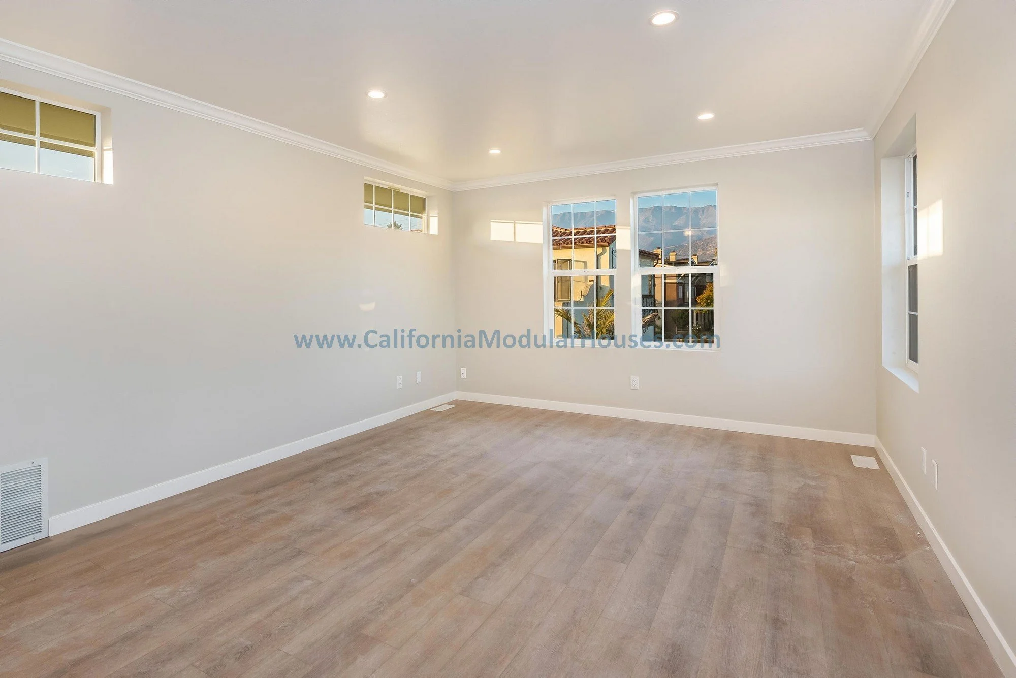 French oak floors of a prefab modular two-story home, bright light windows.