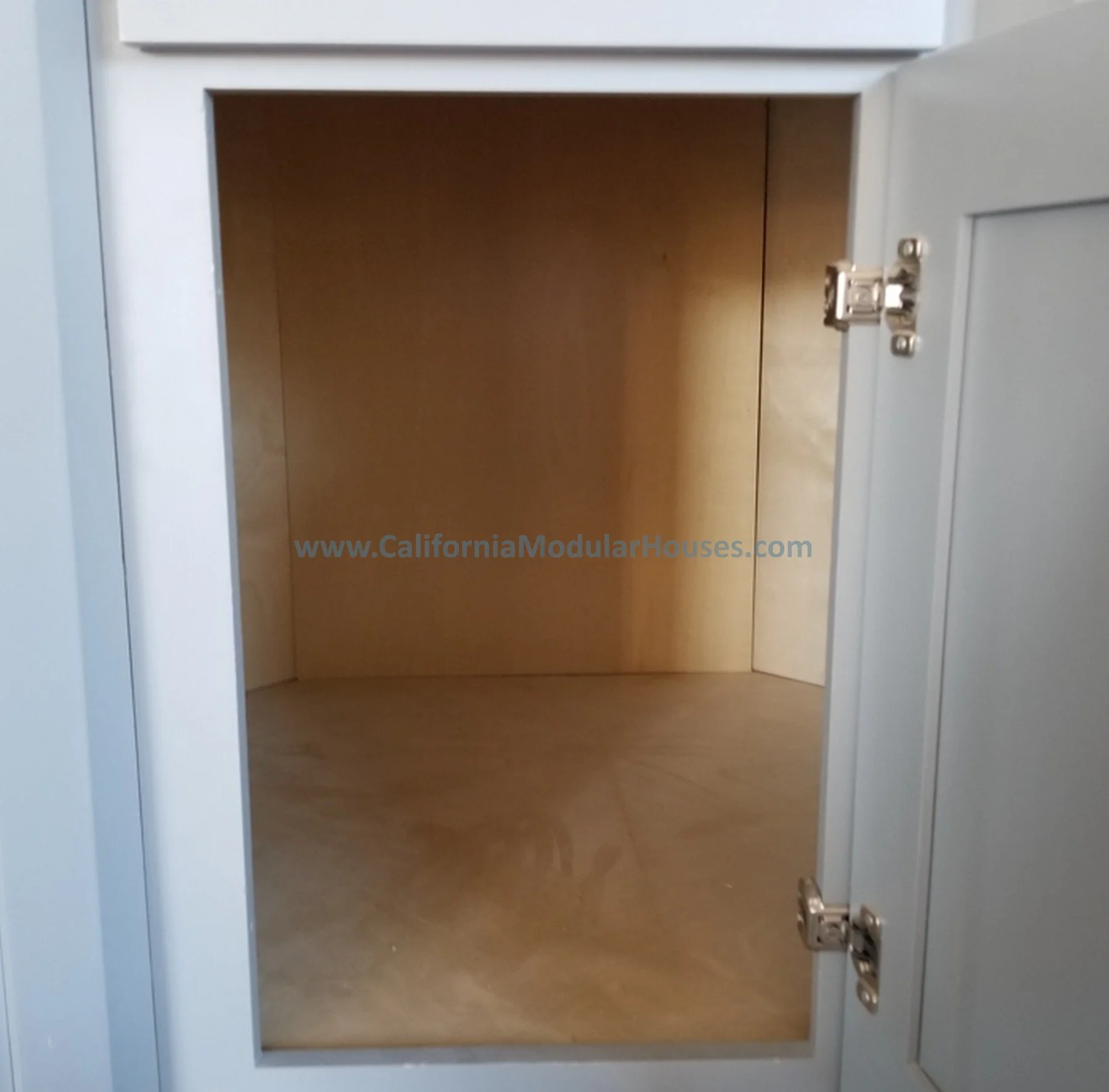 Empty wooden closet with glass door frame and metal hinges.   Interior picture of Accessory Dwelling Unit Contra Costa County, CA