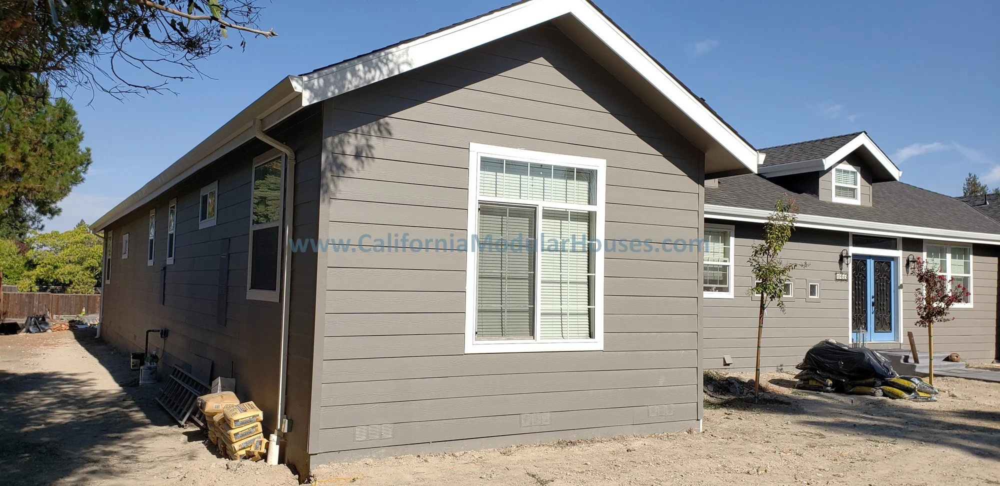 This image shows a perspective of the side of the home with plenty of windows, this is while the modular home is being completed on-site.  California South Bay.  