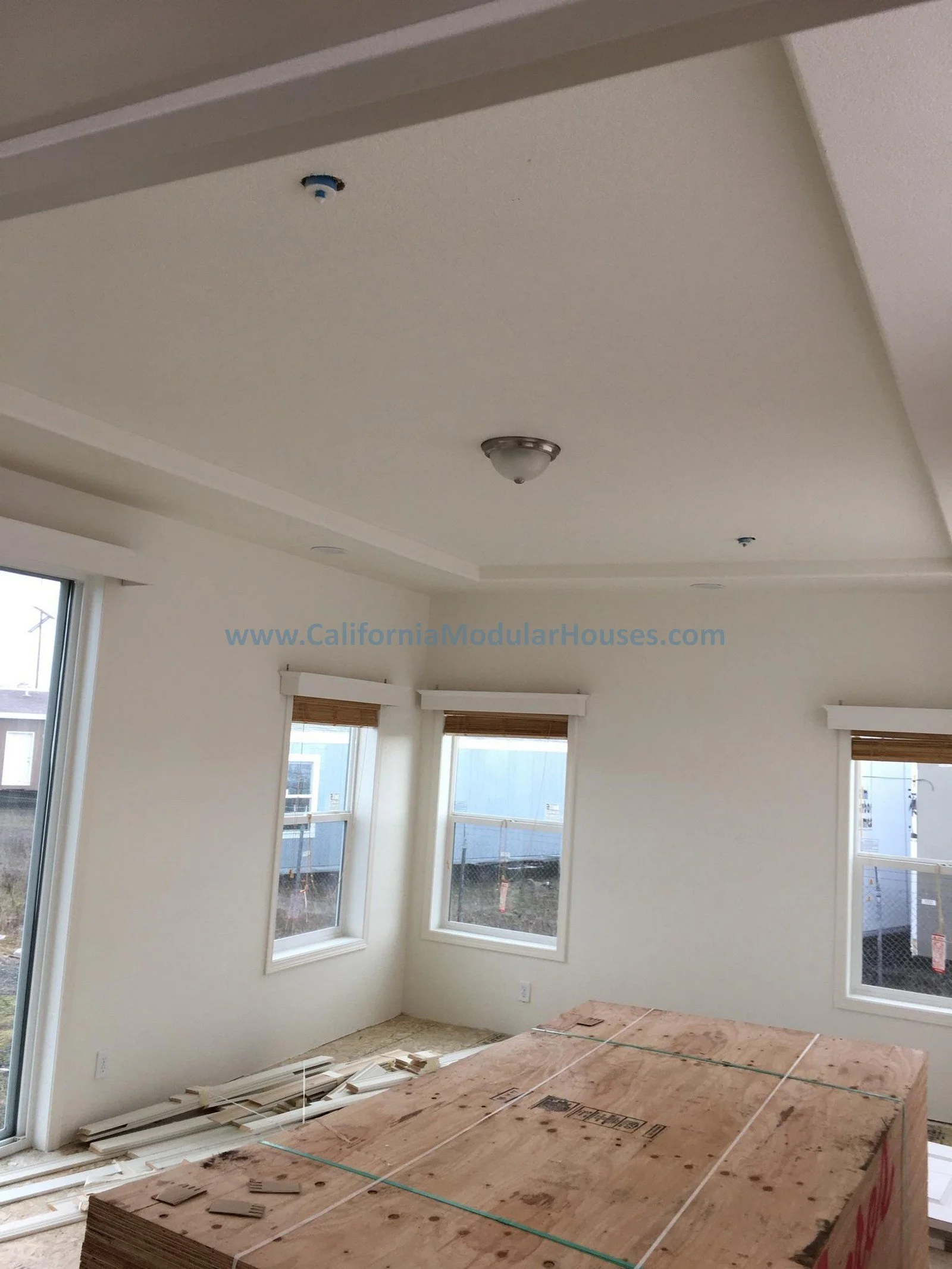 Interior of a one of our homes that is being built showing windows and the ceiling with the lighting for one of our Factory Built Homes.  