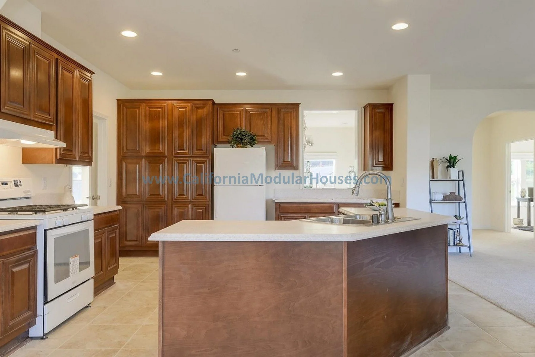 Kitchen with wooden cabinets, white appliances, and an island with a sink. Modular Homes, California Modular Home,  California Modular, San Jose, Santa Clara County, CA.