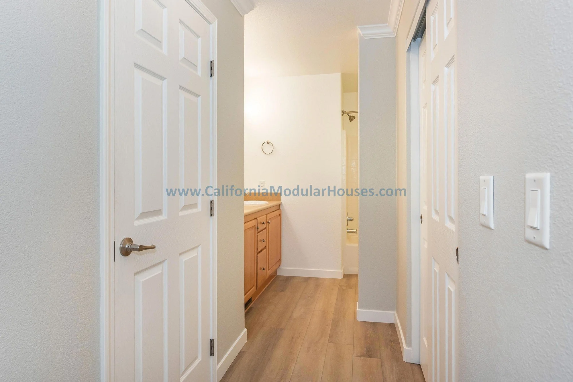 French oak floors of a prefab modular two-story home, bathroom view.