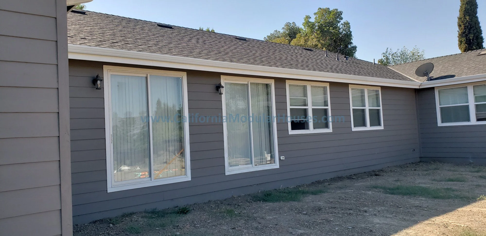 This modular home in Concord, California shows the three sliding glass doors (french doors are also an option) and many window throughout the home.  