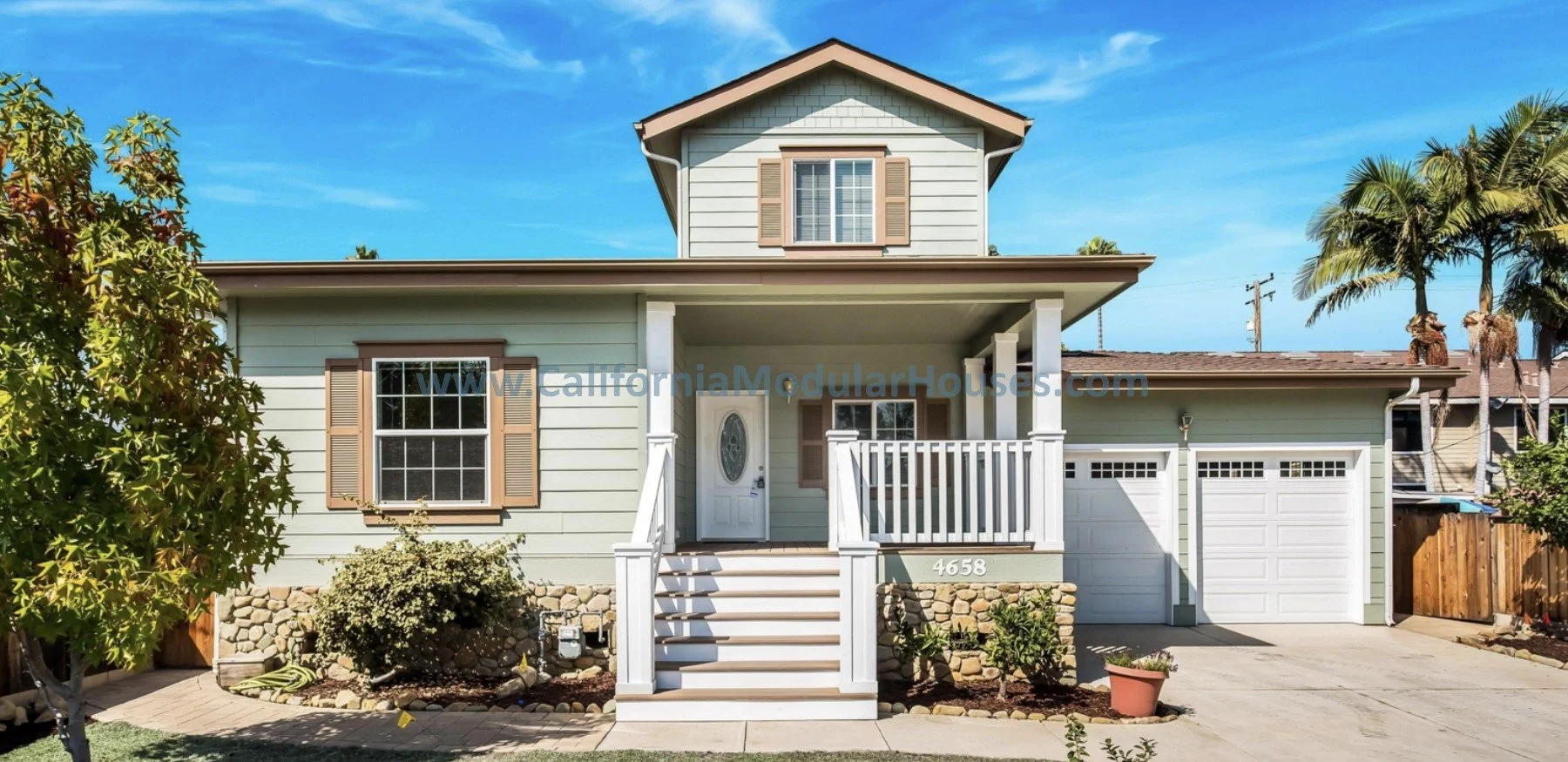 Green siding and brown trim, prefab modular two-story home in Carpinteria, Santa Barbara County, California.