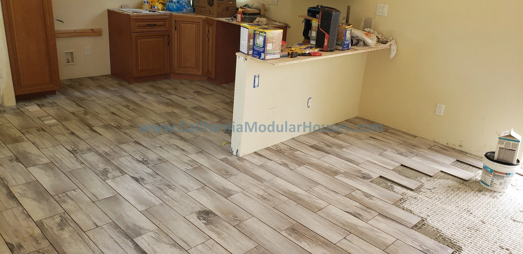 Kitchen & living area wood-look tile flooring, cabinets. Healdsburg, Sonoma County, CA. Prefab Modular ADU 

